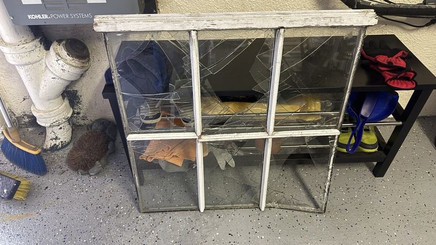Old wood window sash with failed glazing and damaged glass before restoration
