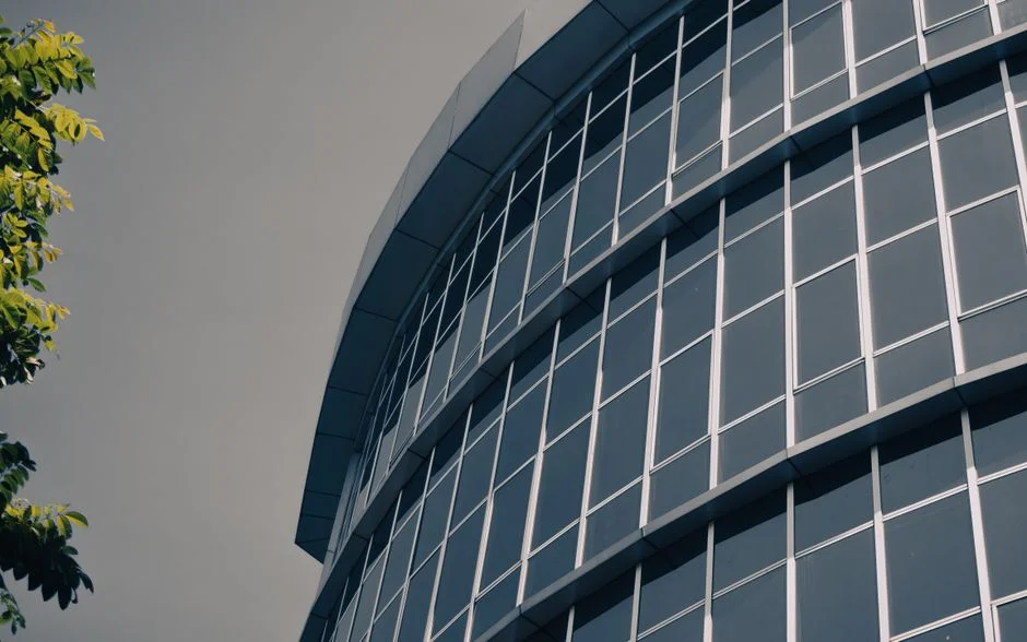 Modern architectural glass showing low-E coating reflection