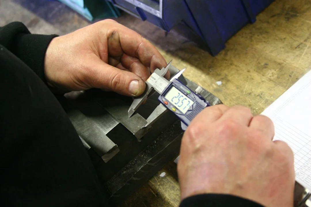 Technician measuring a metal channel balance for replacement - window balance repair