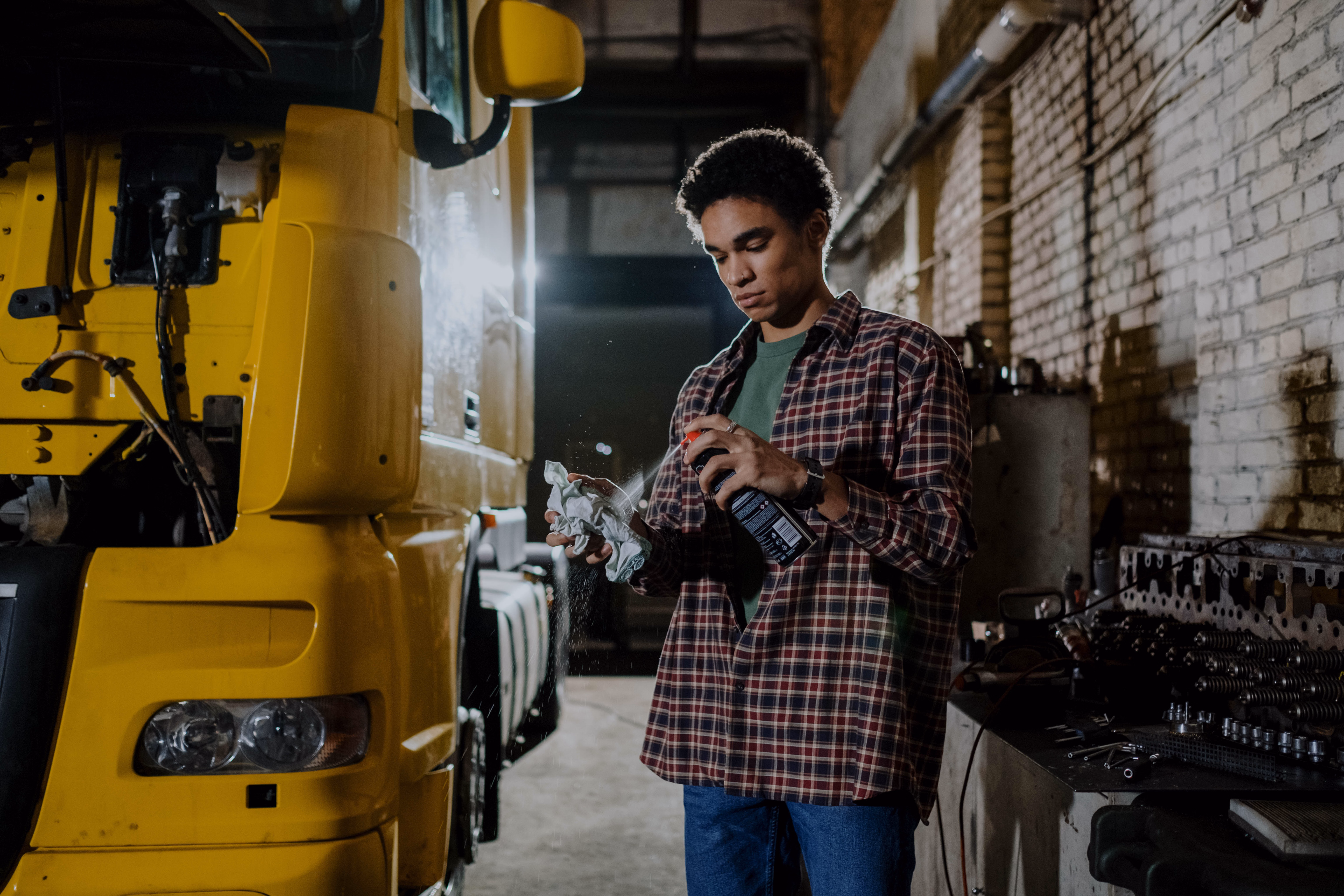 A technician applying silicone spray to a clean window track - window channel balance repair A technician applying silicone spray to a clean window track - window channel balance repair