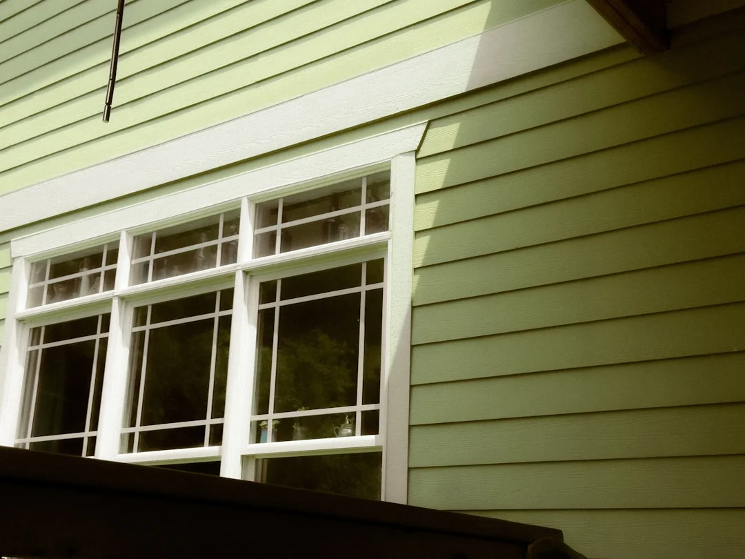Freshly painted and sealed window trim on a modern home exterior